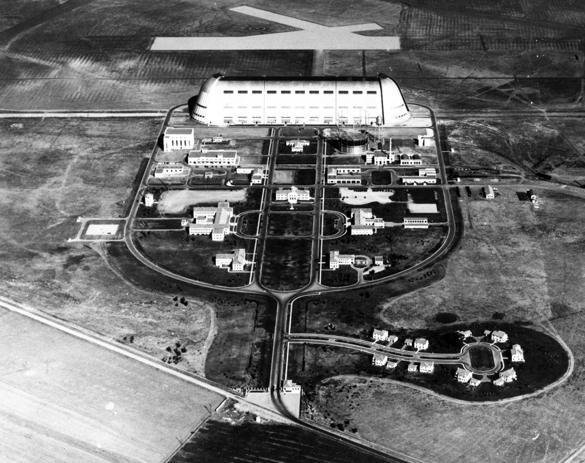A birds-eye view of enormous Hangar 1, its adjacent airfield, and the roads, buildings, and central open space of the area called Shenandoah Plaza.